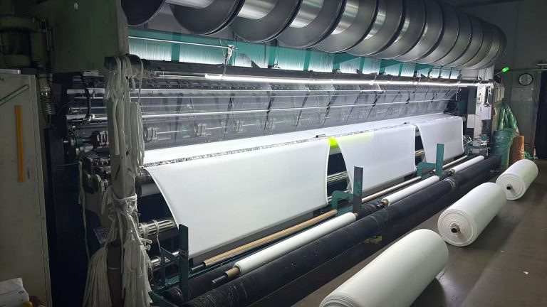 Finished fabric rolls on the warp knitting line